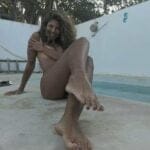 Tanned body by the pool